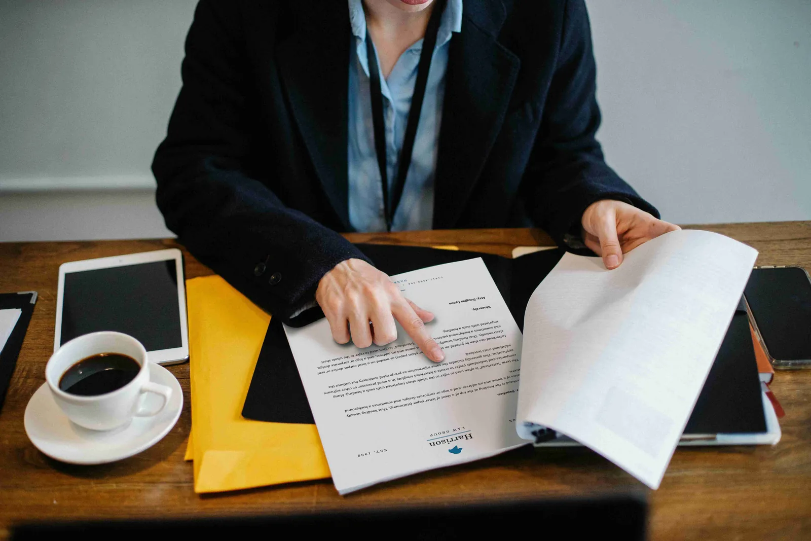 A woman reviewing detailed graphs and data tables on her desk