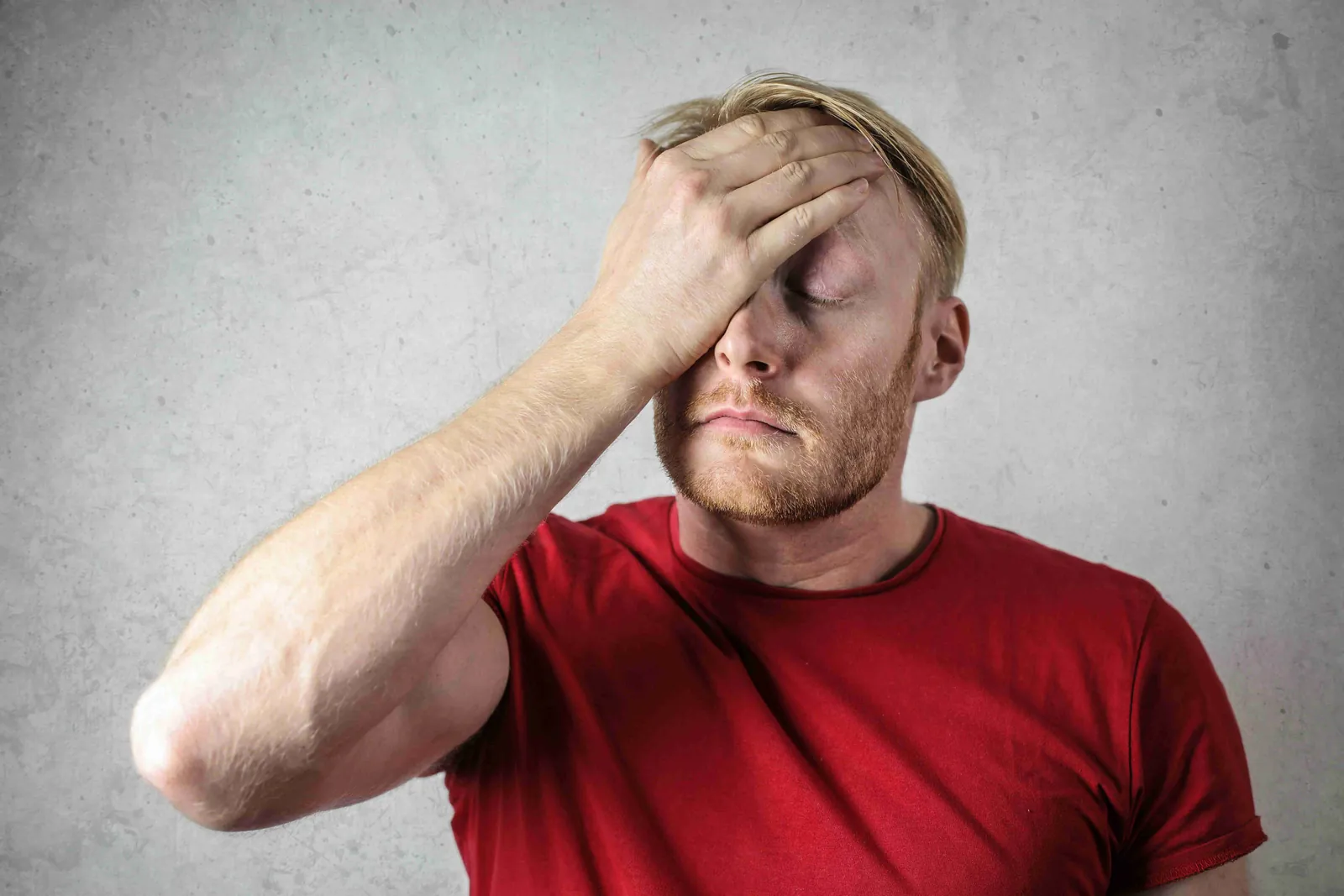 A stressed man holding his head due to financial or legal problems